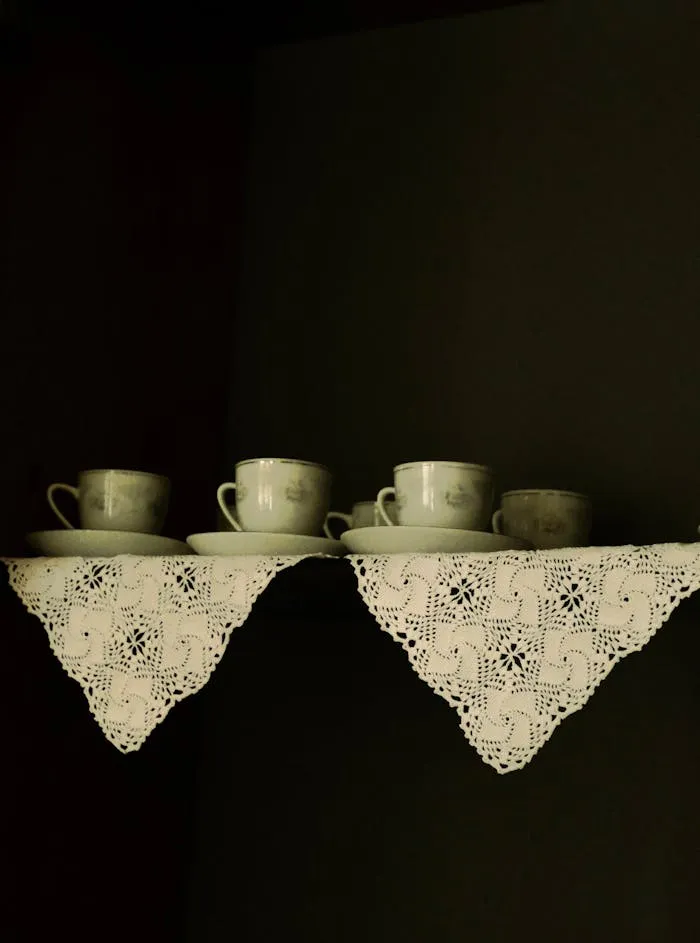 Handwork and a homely arrangement with lace details on a shelf